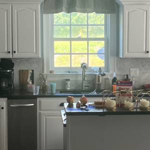 The kitchen is behind the dining room